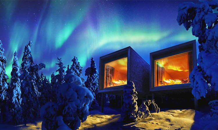 A painting of two windows in the snow with trees and lights