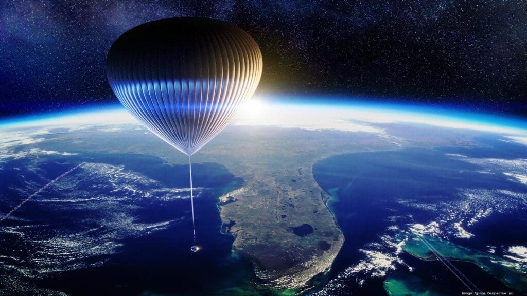 A hot air balloon flying over the ocean.