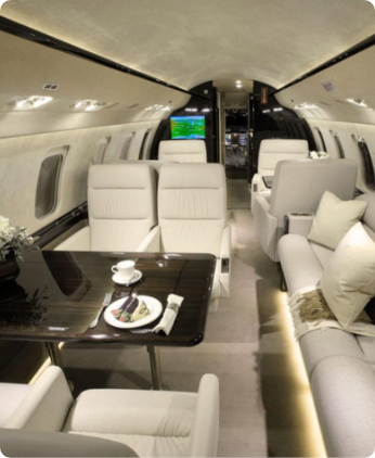 A large jet airplane with white couches and tables.