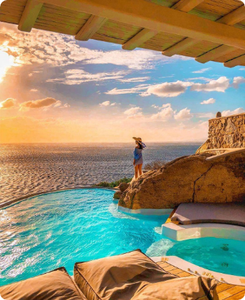 A person standing in the pool at sunset