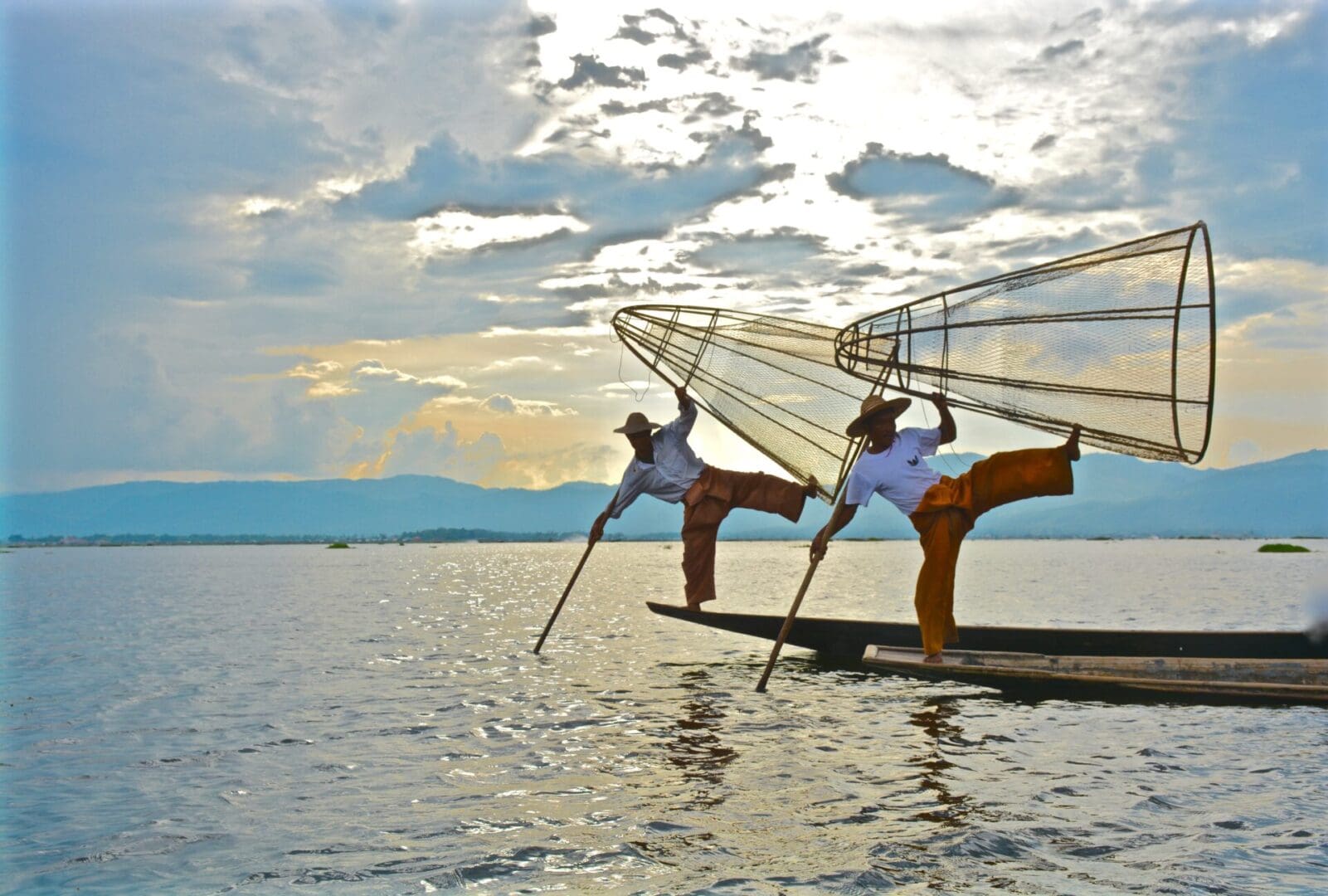 Two people on a boat in the water.