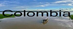 A boat in the water with the word " atomic " written underneath it.