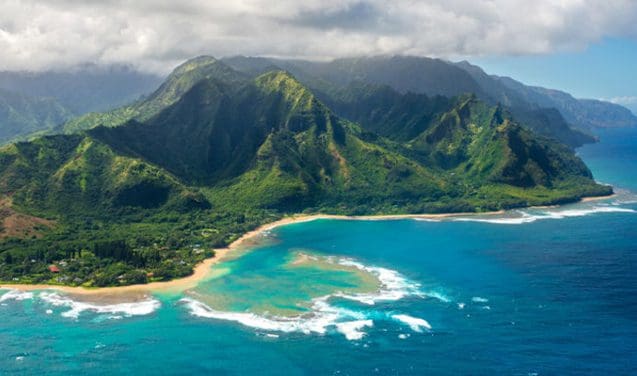 A view of the ocean and mountains from above.