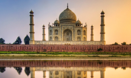 A view of the taj mahal from across the river.