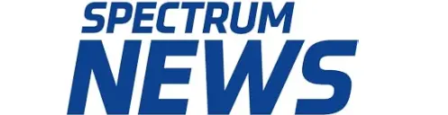 A blue and white logo for spectrum news.