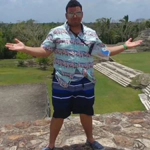 A man standing on top of a stone wall.