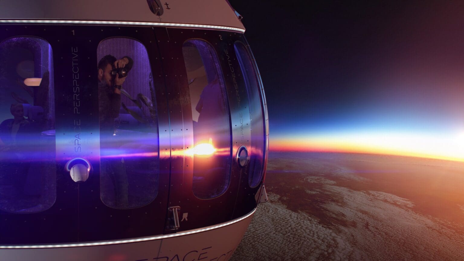 A view of the sun setting from inside an airplane.