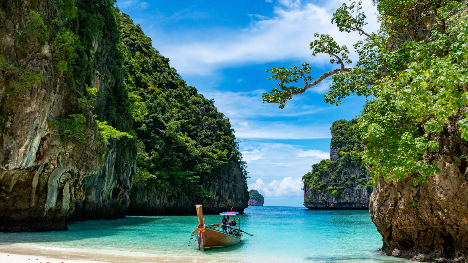 A boat is in the water near some cliffs.