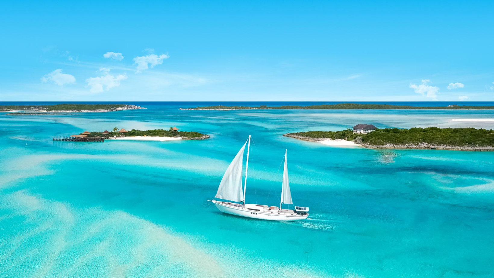 A sailboat in the ocean with trees and bushes around it.