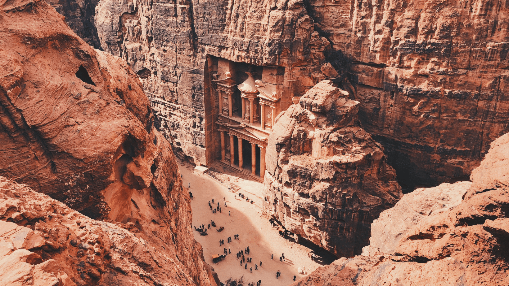 A large group of people are standing in the middle of a canyon.