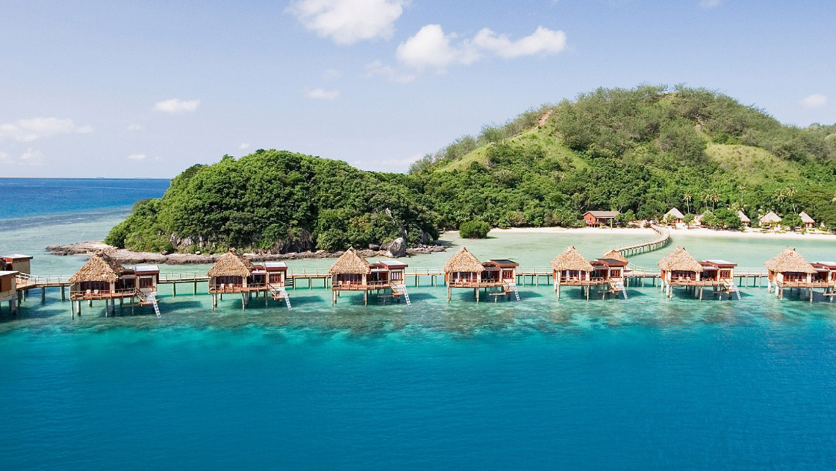 A group of houses on stilts in the water.